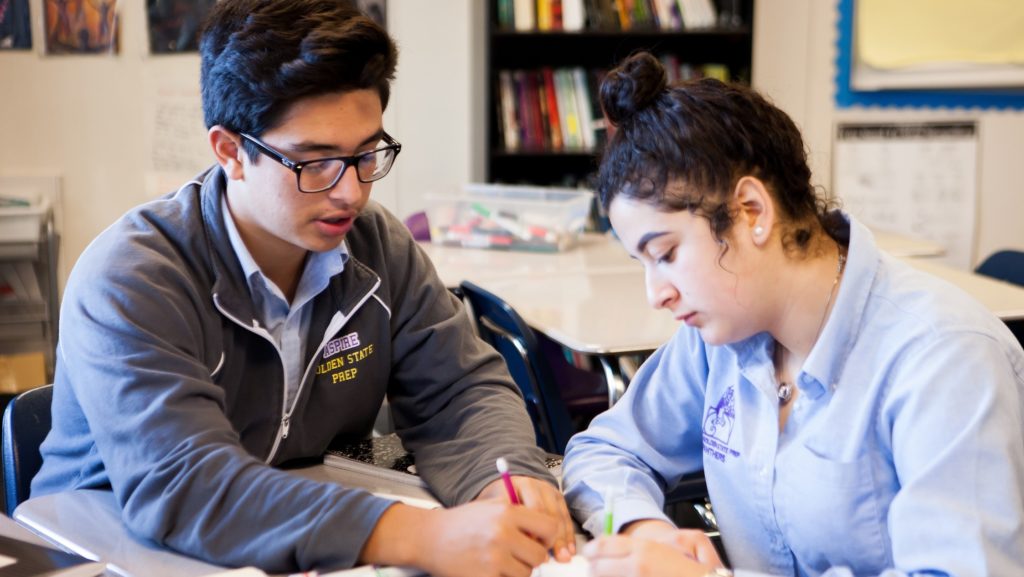 Two Aspire students working together at a desk