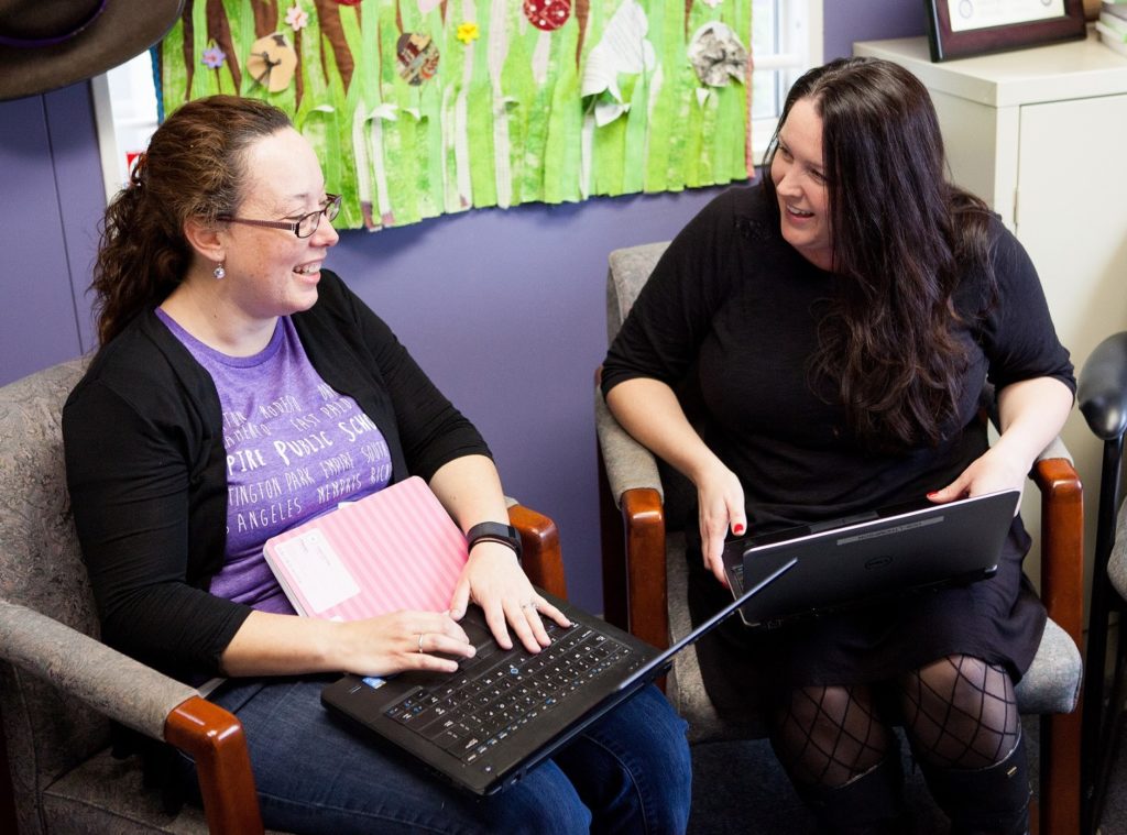 Two Aspire teammates on their laptops