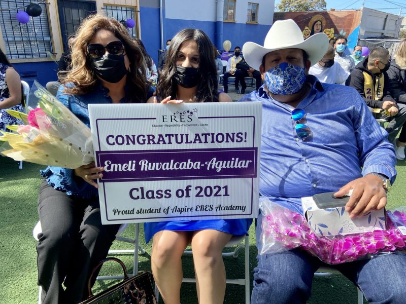 Emeli Ruvalcaba-Aguilar, center, with her family at Aspire ERES Academy’s eighth grade promotion ceremony on Tuesday, June 8, 2021. Credit: Ashley McBride