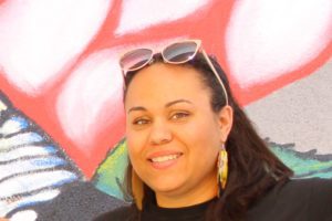 Headshot of Kelly Ware against graffiti background